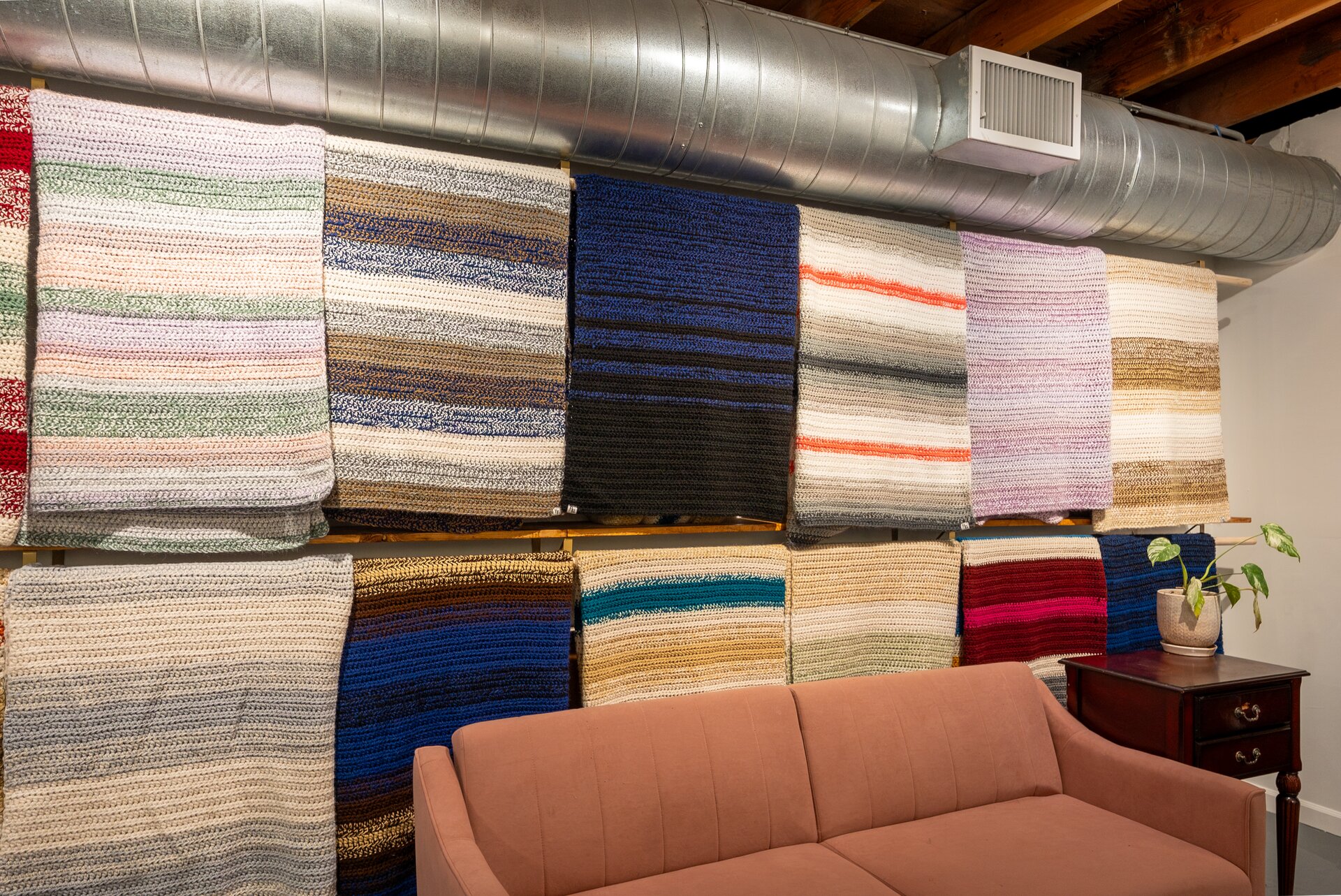 Wall of handcrafted blankets in the Bailey's Blankets showroom