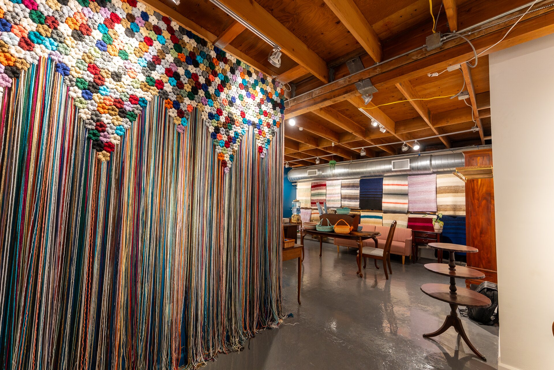 Crochet archway installation and blanket wall inside Bailey's Blankets storefront
