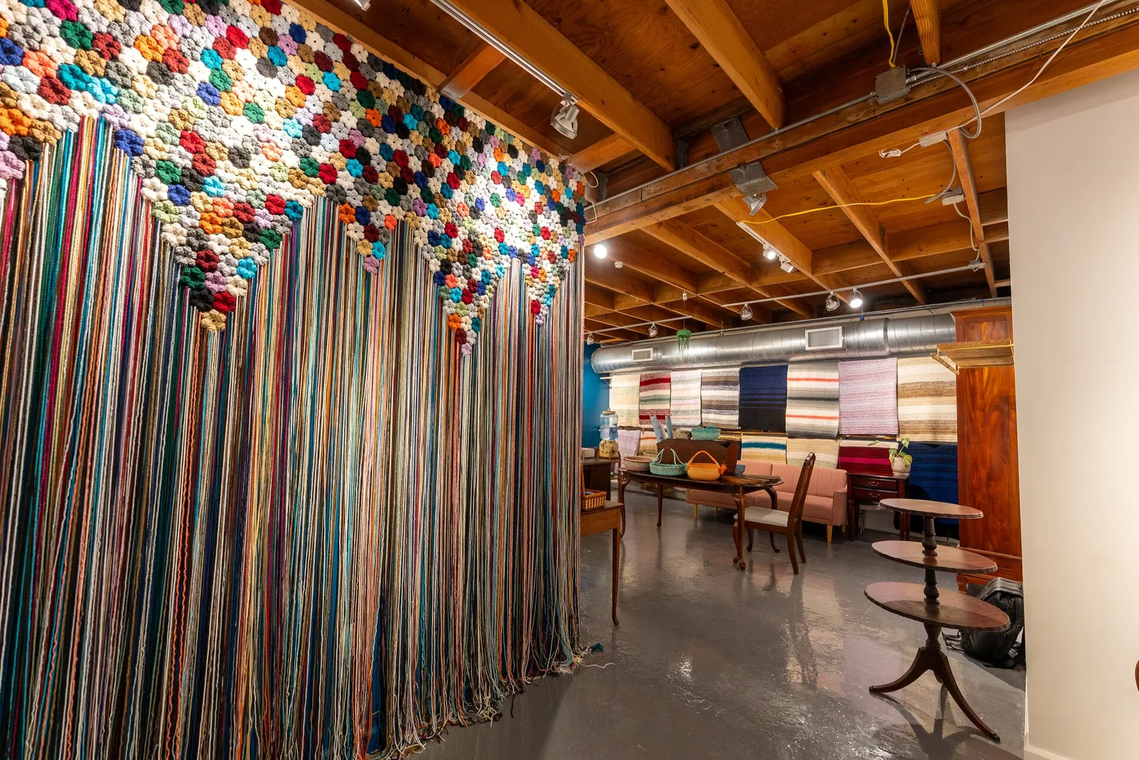 Crochet archway installation and blanket wall inside Bailey's Blankets storefront